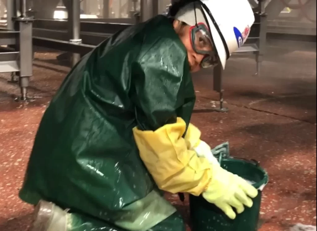 Image of a child working cleaning a slaughterhouse